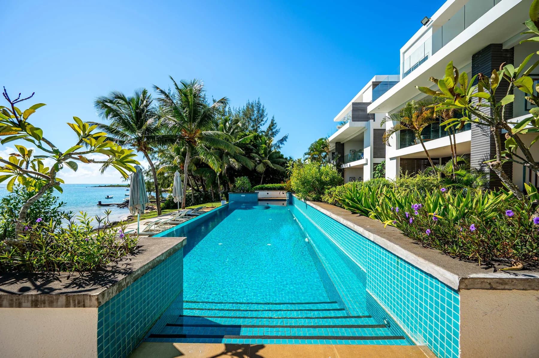 Cover photograph for Coral Bay – Jardin les pieds dans l’eau & piscine.